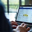 Fleet manager viewing digital report on laptop